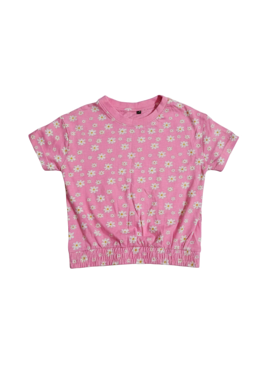 Pink t-shirt with small white floral pattern on a white background